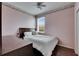 Comfortable bedroom with ceiling fan, window view, and classic floral wallpaper border at 10328 Celtic Ash Dr, Ruskin, FL 33573