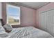 Well-lit bedroom offers a window view and convenient double door closet at 10328 Celtic Ash Dr, Ruskin, FL 33573