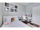 Bright bedroom features modern decor, a cozy bed, and a functional desk area at 10328 Celtic Ash Dr, Ruskin, FL 33573