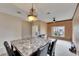 Inviting dining room with a decorative chandelier and natural light from the window at 10328 Celtic Ash Dr, Ruskin, FL 33573
