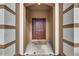 Front door of home under covered porch with concrete and Alumni floor mat at 10328 Celtic Ash Dr, Ruskin, FL 33573