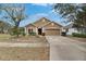Inviting single-story home with a well-maintained lawn and two car garage at 10328 Celtic Ash Dr, Ruskin, FL 33573