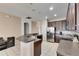 Open concept kitchen with dark wood cabinets, stainless steel refrigerator, and white tile floors at 10328 Celtic Ash Dr, Ruskin, FL 33573