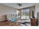 Bright living room with sliding glass doors, offering a view of the backyard and plenty of natural light at 10328 Celtic Ash Dr, Ruskin, FL 33573