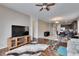 Spacious living room with a ceiling fan, hardwood floors, and an open layout leading to the kitchen at 10328 Celtic Ash Dr, Ruskin, FL 33573
