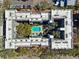 Aerial view of the building shows a central pool surrounded by trees and a parking area to the left of the building at 105 4Th Ne Ave # 418, St Petersburg, FL 33701