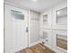 Charming entryway with white door, wood floors, and decorative mirrors on the wall at 105 4Th Ne Ave # 418, St Petersburg, FL 33701