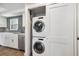 Convenient stacked washer and dryer in closet, complemented by nearby kitchen with modern backsplash at 105 4Th Ne Ave # 418, St Petersburg, FL 33701