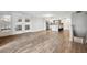 Spacious living room with wood floors, mirror feature, and easy access to the open-concept kitchen at 105 4Th Ne Ave # 418, St Petersburg, FL 33701