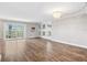 Spacious living room with wood floors, large windows, and a decorative chandelier fixture at 105 4Th Ne Ave # 418, St Petersburg, FL 33701