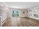 Bright living room featuring hardwood floors, built-in shelving, and sliding glass doors at 105 4Th Ne Ave # 418, St Petersburg, FL 33701