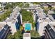 A high angle of a pool surrounded by tropical plants nestled between condo units with balconies at 105 4Th Ne Ave # 418, St Petersburg, FL 33701