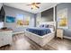 Large main bedroom with wood floors, plenty of natural light, and a decorative ceiling fan at 10946 Gun Dog Way, Lithia, FL 33547