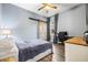 Bedroom with light blue walls, wood-look floors, barn door, and a corner desk setup at 10946 Gun Dog Way, Lithia, FL 33547