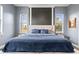 Serene bedroom with neutral walls, symmetrical windows, and a plush bed for ultimate relaxation at 10946 Gun Dog Way, Lithia, FL 33547