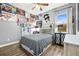 Cozy bedroom with fun posters, black and white bedspread, and a bright window at 10946 Gun Dog Way, Lithia, FL 33547