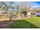 Fenced in corral with shelter and a trailer at 10946 Gun Dog Way, Lithia, FL 33547