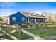 Beautiful two-story blue home with a charming fence and lush green grass at 10946 Gun Dog Way, Lithia, FL 33547