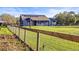 Blue home with a big yard and solar panels on the roof at 10946 Gun Dog Way, Lithia, FL 33547