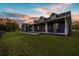 Charming blue home with a welcoming front porch, rocking chairs, and manicured lawn at sunset at 10946 Gun Dog Way, Lithia, FL 33547