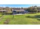 Rear exterior of a charming home with a paved patio and lush green yard at 10946 Gun Dog Way, Lithia, FL 33547