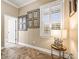 Hallway nook with framed botanical prints, plantation shutters, and a decorative accent table at 10946 Gun Dog Way, Lithia, FL 33547