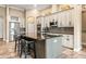 Gourmet kitchen with an island, granite countertops, custom cabinets, stainless steel appliances, and tiled floor at 10946 Gun Dog Way, Lithia, FL 33547