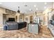 Open-concept living room with a kitchen island, leather sofa, and decorative wall art at 10946 Gun Dog Way, Lithia, FL 33547