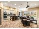 Open-concept living space with tile flooring, a kitchen island, and high-end finishes at 10946 Gun Dog Way, Lithia, FL 33547