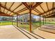Covered patio area with views of the farmhouse and manicured lawn at 10946 Gun Dog Way, Lithia, FL 33547