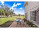 Back patio includes an outdoor dining set and overlooks the expansive lawn at 11050 Revell Rd, Duette, FL 34219