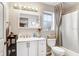 Bright bathroom featuring a vanity, decorative mirror, and a shower with a curtain at 11050 Revell Rd, Duette, FL 34219