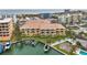 Aerial view showing a large complex with private boat docks and balconies at 11555 Gulf Blvd Blvd # 115, Treasure Island, FL 33706