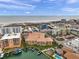 Breathtaking aerial view of a yellow condo building situated on a waterfront with private boat docks and beach access at 11555 Gulf Blvd Blvd # 115, Treasure Island, FL 33706