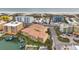 Aerial view showcasing a beachfront complex with private boat docks surrounded by beautiful beaches at 11555 Gulf Blvd Blvd # 115, Treasure Island, FL 33706