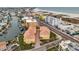 Aerial view of a beach community showcasing waterfront condos, docks, and nearby sandy beaches at 11555 Gulf Blvd Blvd # 115, Treasure Island, FL 33706