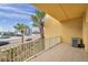 This balcony features beautiful views of the tropical scenery with a bright neutral color palette, and durable tile flooring at 11555 Gulf Blvd Blvd # 115, Treasure Island, FL 33706