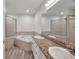 Bright bathroom featuring dual sinks, granite counters, bathtub and glass shower at 11555 Gulf Blvd Blvd # 115, Treasure Island, FL 33706