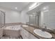 Bright bathroom featuring dual sinks, granite counters, bathtub and glass shower at 11555 Gulf Blvd Blvd # 115, Treasure Island, FL 33706