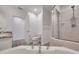 Bright bathroom featuring a bathtub, toilet and glass shower at 11555 Gulf Blvd Blvd # 115, Treasure Island, FL 33706