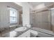 Bathroom with a granite-top vanity, mirror, toilet, and a tiled shower and tub at 11555 Gulf Blvd Blvd # 115, Treasure Island, FL 33706