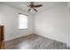 Bedroom with hardwood floors, ceiling fan, and a window with blinds at 11555 Gulf Blvd Blvd # 115, Treasure Island, FL 33706