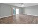 Bright bedroom with wood floors, ceiling fan, and balcony access at 11555 Gulf Blvd Blvd # 115, Treasure Island, FL 33706