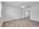 A spacious bedroom with hardwood floors, a ceiling fan, and a closet at 11555 Gulf Blvd Blvd # 115, Treasure Island, FL 33706