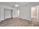 A spacious bedroom with hardwood floors, a ceiling fan, and a bathroom at 11555 Gulf Blvd Blvd # 115, Treasure Island, FL 33706