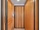 Accessible elevator with wood paneled walls providing easy access between floors of the home at 11555 Gulf Blvd Blvd # 115, Treasure Island, FL 33706