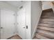 Bright entryway featuring wood stairs, white walls, and doors providing a clean and welcoming atmosphere at 11555 Gulf Blvd Blvd # 115, Treasure Island, FL 33706