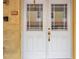 Inviting front door with sidelights, a decorative golden handle and clear address numbers for easy visibility at 11555 Gulf Blvd Blvd # 115, Treasure Island, FL 33706