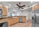 Open kitchen with stainless steel appliances and wood-style flooring, blending style and functionality at 11555 Gulf Blvd Blvd # 115, Treasure Island, FL 33706