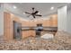 Kitchen with wooden cabinetry, granite countertops, and stainless steel appliances, a chef's dream at 11555 Gulf Blvd Blvd # 115, Treasure Island, FL 33706